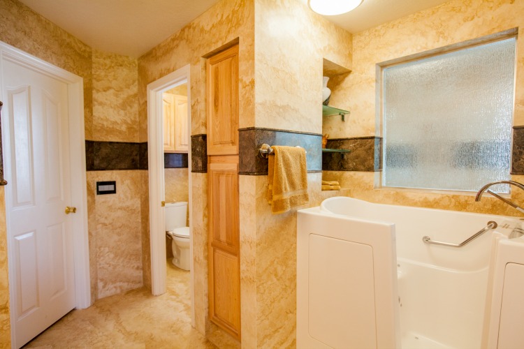 Master bathroom addition in Phoenix, Arizona -  featuring Forza Stone panels, an accessible shower and a walk-in jetted tub.