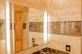 Master bathroom addition in Phoenix, Arizona -  featuring Forza Stone panels, an accessible shower and a walk-in jetted tub.
