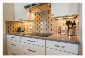 Phoenix AZ Open Concept galley kitchen with white cabinets and gray quartz countertops. 