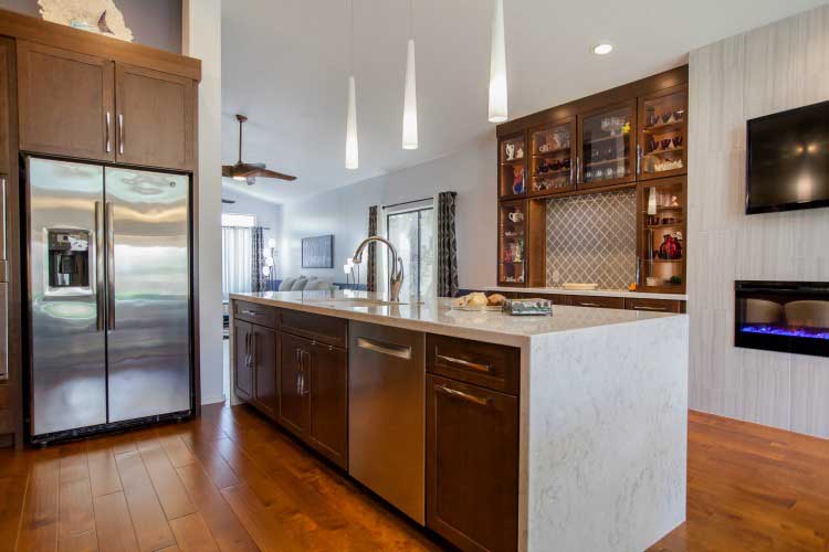 Kitchen Remodeling contractor in Mesa, AZ. Large open concept modern style kitchen remodel with island seating, stainless appliances and cherry cabinets.