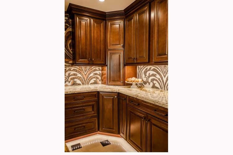 Paradise Valley Kitchen remodeling Contractor-Luxurious kitchen renovation with a large island, two toned wood cabinets, a stone cook-top hood and LED lighting.