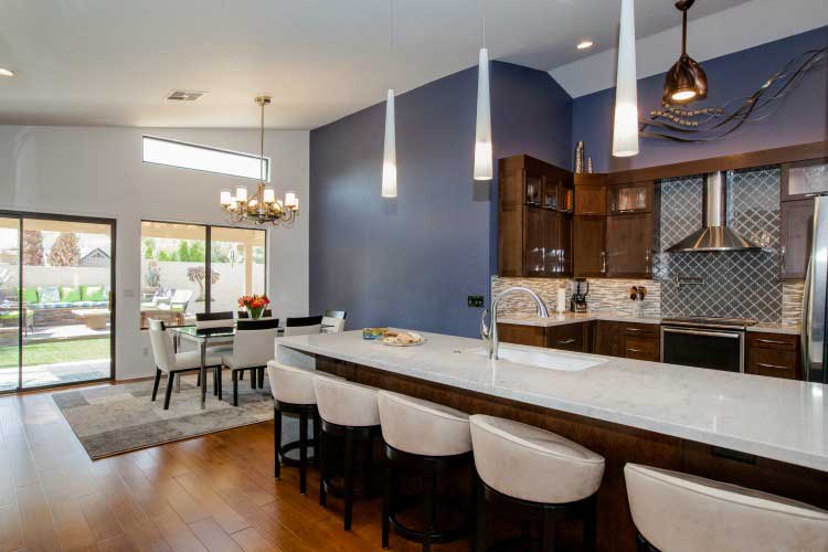 Kitchen Remodeling contractor in Mesa, AZ. Large open concept modern style kitchen remodel with island seating, stainless appliances and cherry cabinets.