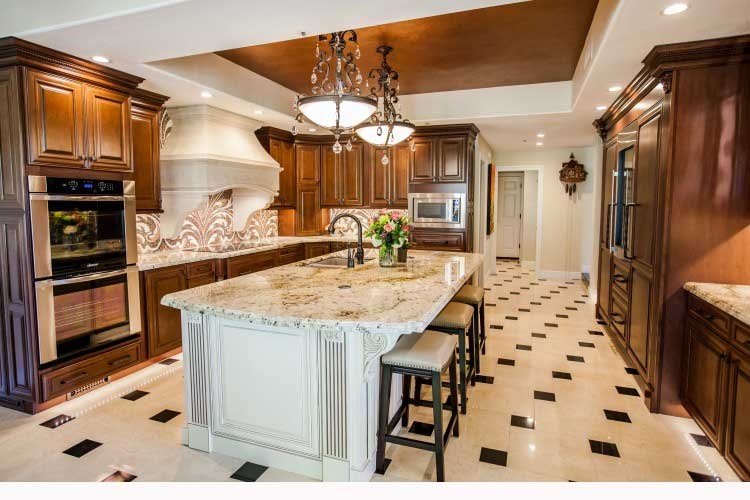 Award winning Scottsdale Kitchen Transformation. Upscale Scottsdale kitchen remodel with rich custom cabinets, a large center island, a stone cook-top hood and LED lighting.