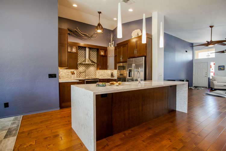 Kitchen Remodeling contractor in Mesa, AZ. Large open concept modern style kitchen remodel with island seating, stainless appliances and cherry cabinets.