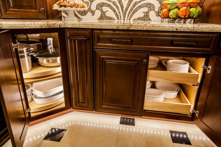 Award winning Scottsdale Kitchen Transformation. Upscale Scottsdale kitchen remodel with rich custom cabinets, a large center island, a stone cook-top hood and LED lighting.