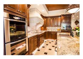 Gilbert AZ open concept kitchen remodel with dark wood cabinets and island seating.