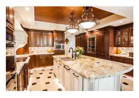 Chandler AZ open concept kitchen remodel with dark wood cabinets a white island and quartz counter tops.