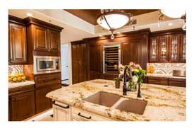 Gilbert AZ open concept kitchen remodel with dark wood cabinets and island seating.