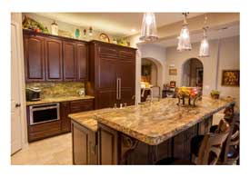 Open Concept kitchen with dark wood cabinets granite counters and island seating in Phoenix AZ.