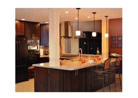 Gilbert AZ open concept kitchen remodel with dark wood cabinets and peninsula seating.