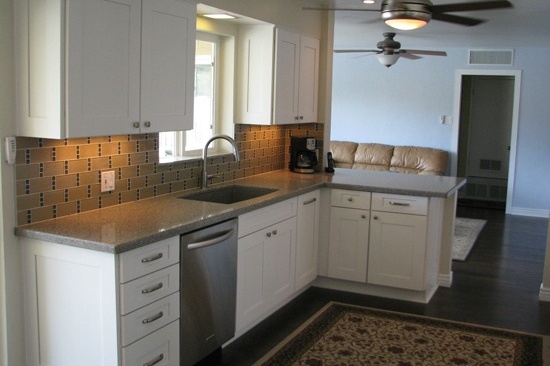 Mesa, AZ kitchen remodeling contractor. Open concept galley kitchen with gray quartz counter tops and white cabinets.