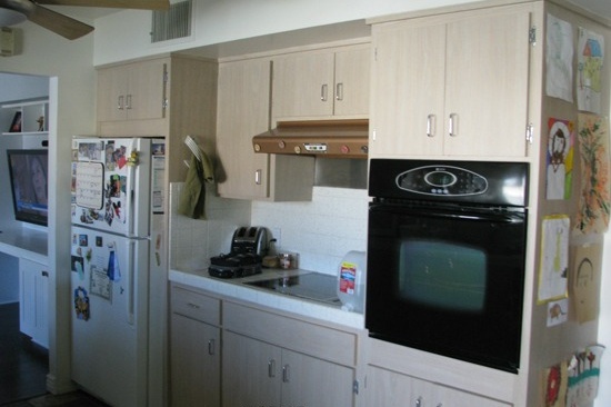 Mesa, AZ kitchen remodeling contractor. Open concept galley kitchen with gray quartz counter tops and white cabinets.
