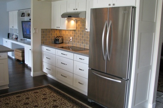 Kitchen Remodeling Contractor in Phoenix, AZ. Open concept galley kitchen renovation with gray quartz counter tops and white cabinets.