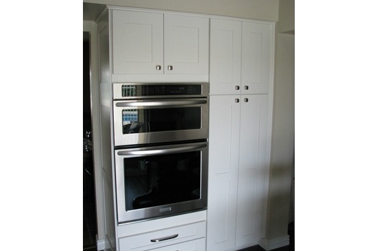 Kitchen Remodeling Contractor in Phoenix, AZ. Open concept galley kitchen renovation with gray quartz counter tops and white cabinets.