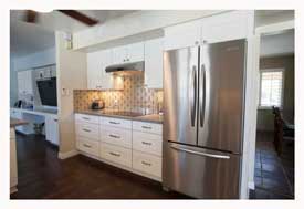 Phoenix AZ Open Concept galley kitchen with white cabinets and gray quartz countertops. 