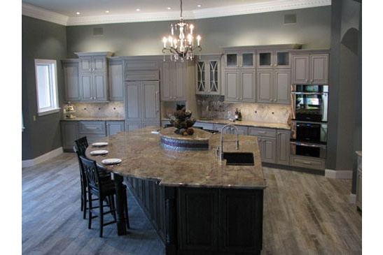 Scottsdale kitchen remodeling contractor featuring an open, modern kitchen, large functional island and chandelier.