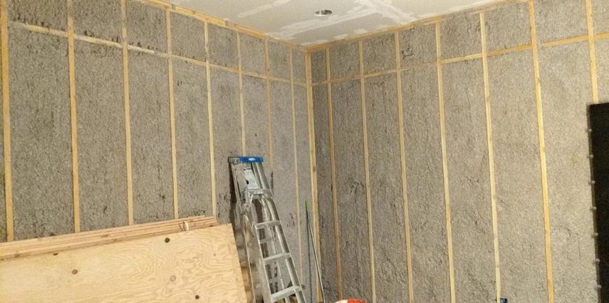 All that blown insulation settled into its spaces. Drywall installed on the ceiling. Plywood acclimating so it can be ready to sheet the walls once the ceiling is complete.